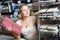 Positive young woman customer buying tablecloths