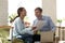 Positive young woman employee laughing, enjoying break time with coworker.