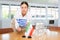 Positive young woman putting little flag of Greece on table next to the flag of Iran