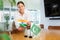 Positive young woman putting little flag of India on table next to the flag of Pakistan