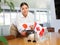 Positive young woman putting little flag of Japan on table next to the flag of Canada
