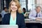 Positivity boosts my productivity. Portrait of a businesswoman using a laptop at her desk with her colleagues in the