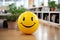 Positivity in the workplace demonstrated by a yellow smiling ball in the office interior