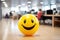 Positivity in the workplace demonstrated by a yellow smiling ball in the office interior