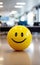 Positivity in the workplace demonstrated by a yellow smiling ball in the office interior