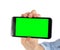 The possibilities are endless...Closeup shot of a woman holding a mobile phone with green screen copyspace.