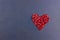 Post Card with Heart of fresh pomegranate on background of painted stone Closeup. Romantic Valentines day concept