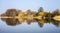 Post Cistercian Structures in Bierzwnik village (part of Cistercian Trail in Poland) reflected in lake, Poland.