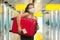 Post covid19 new normal traveling - young happy and beautiful tourist Asian Korean woman in face mask with trolley suitcase at