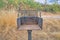 Post-mounted rusty campground grill against a shrubland in Tucson, Arizona