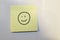 Post-it note with a happy face drawn