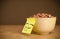 Post-it note with smiley face sticked on cereal bowl