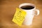 Post-it note with smiley face sticked on a cup