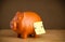 Post-it note with smiley face sticked on piggy bank