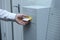 At the post office: female hand taking a slip with number of order from an electronic terminal for receiving orders