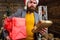 Post for santa claus. Man bearded hipster wear santa hat hold bunch of letters and gift box. Man mature bearded with