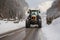 Post-snowstorm scene: Tractor clears road, unveiling its path from the recent snowfall.