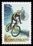 Postage stamp printed in Finland shows Cyclist going downhill & woman with penny farthing bicycle, 100 Years Finnish Cycling