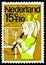 Postage stamp printed in Netherlands shows Girl playing flute, Children Stamps serie, circa 1964