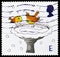 Postage stamp printed in United Kingdom shows Robins skating on Bird Bath, Christmas serie, circa 2001