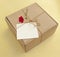 Postal cardboard box  with a flower and a white blank