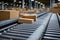 Postal cardboard box packages moving along conveyor belt in warehouse fulfillment center.