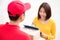 Postal delivery man delivering boxes to a woman