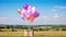 Postal service, shop delivery and online shopping, flying balloons carrying a parcel box in the countryside on a sunny day,