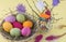 Postcard, bright easter eggs in a wicker basket top view