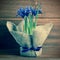 Postcard of iris flowers in burlap on wooden background, closeup