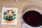 Postcard paper with flower and glass of red wine