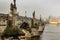 Postcard view of Charles Bridge and Lesser Town in mist,Czech republic.Famous tourist destination.Prague panorama.Foggy morning in