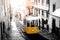 Postcard of yellow tram on old streets of Lisbon, Portugal. Black and white picture with a coloured tram