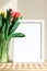 Poster with copy space in warm shades . Mockup of a wooden frame with tulips. White, minimalism. copy space. Mock up design