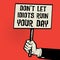 Poster in hand, text Don`t Let Idiots Ruin Your Day