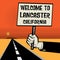 Poster in hand, text Welcome to Lancaster, California