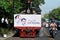 A poster of Joko Widodo-Kalla in front of a steam train