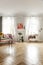 Poster, plants and cupboard in bright loft interior