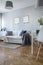 Posters on grey wall in stylish living room interior in fashionable flat