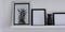 Posters with pineapple and clean frames on shelf, modern interior, banner