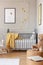 Posters on the walls of baby bedroom with grey and yellow design