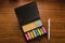 Postics notebook of different colors, sizes and shapes, with a pen for writing work notes, these office supplies are on a desk