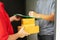 Postman delivering package of goods to home. Selective focus on the hands. Home delivery concept, Deliver packages to recipients