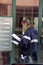 Postman postwoman, woman letter carrier with mail bag