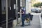 Postman putting letters in mail boxes in the street