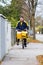 Postman riding his cargo bike carrying out mail