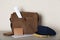 Postman`s hat near bag with letters and newspapers on wooden background