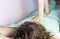 A postpartum doula gives a woman a manual back massage.