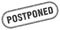 Postponed stamp. rounded grunge textured sign. Label