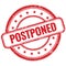 POSTPONED text on red grungy round rubber stamp